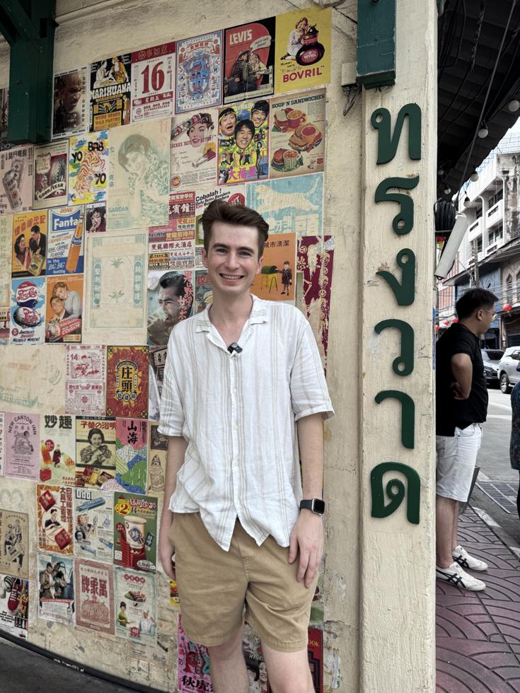 Stuart at the vintage poster wall on Song Wat Road, Bangkok Chinatown